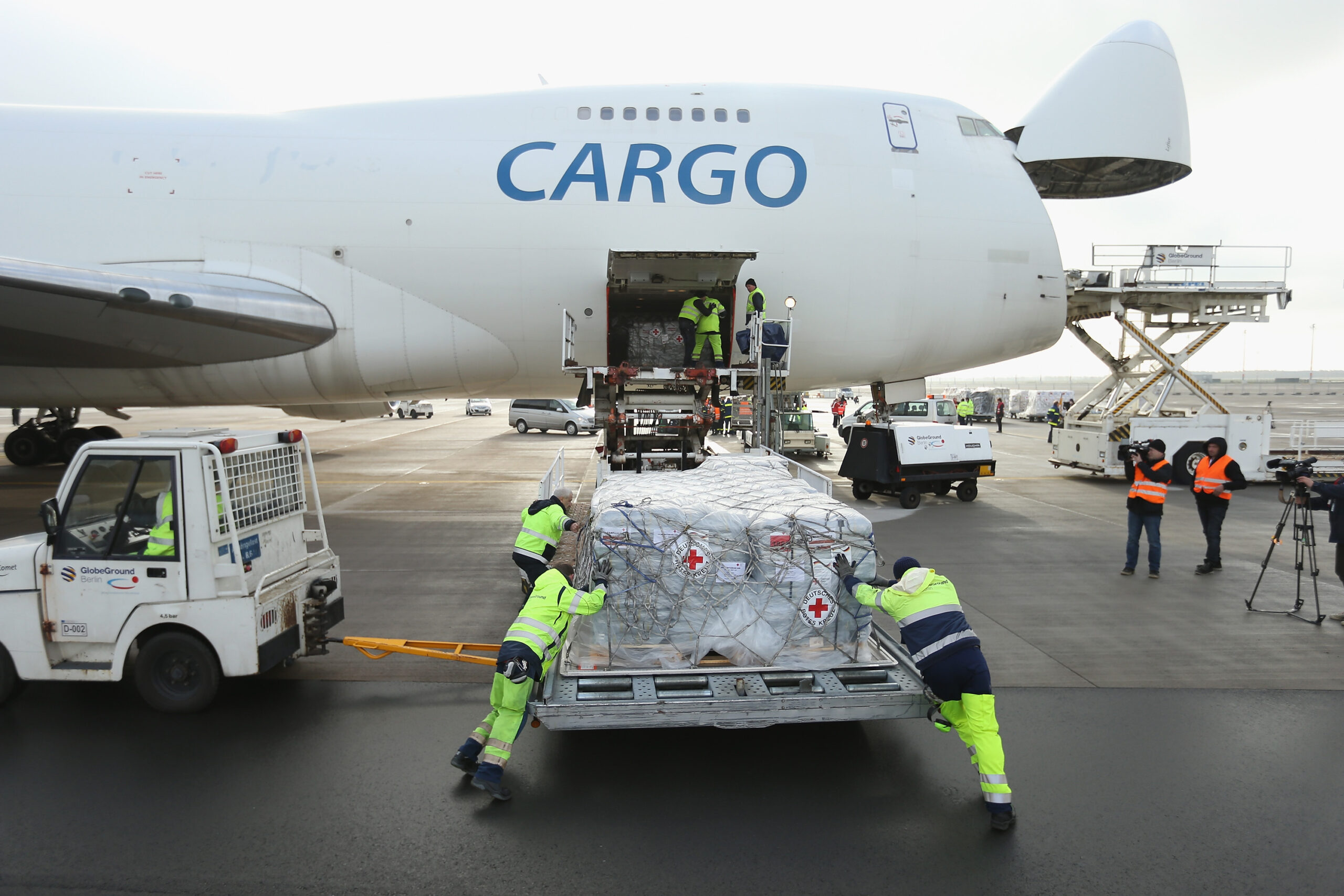 SCHOENEFELD, GERMANY - NOVEMBER 13:  Workers load a shipment of aid from the German Red Cross (DRK) destined for the Philippines on to a Boeing 747 cargo plane at Schoenefeld Airport on November 13, 2013 in Schoenefeld, Germany. The German government is sponsoring the aid, which includes tents, hygiene packages, equipment for producing drinkable water and other necessities, to help alleviate the plight of millions of people made homeless by typhoon Haiyan.  (Photo by Sean Gallup/Getty Images)